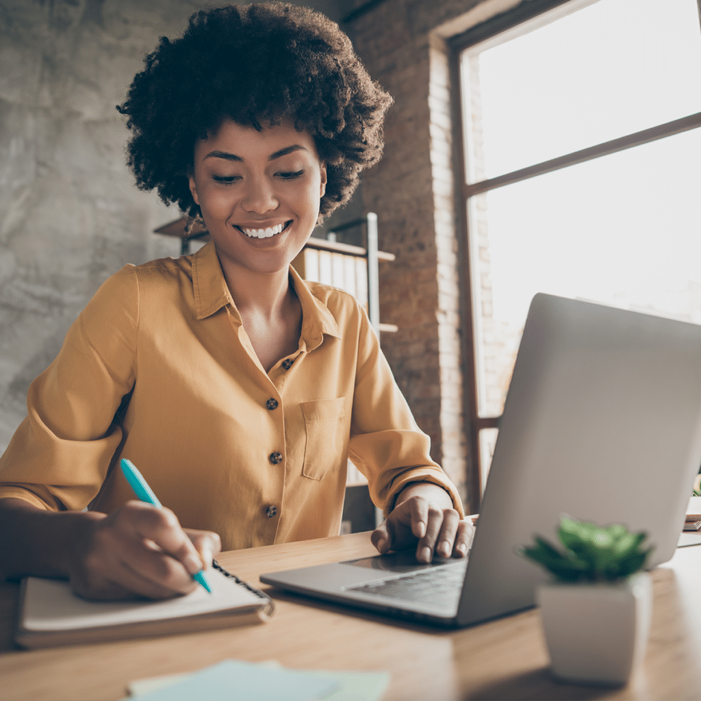 Smiling career woman using laptop