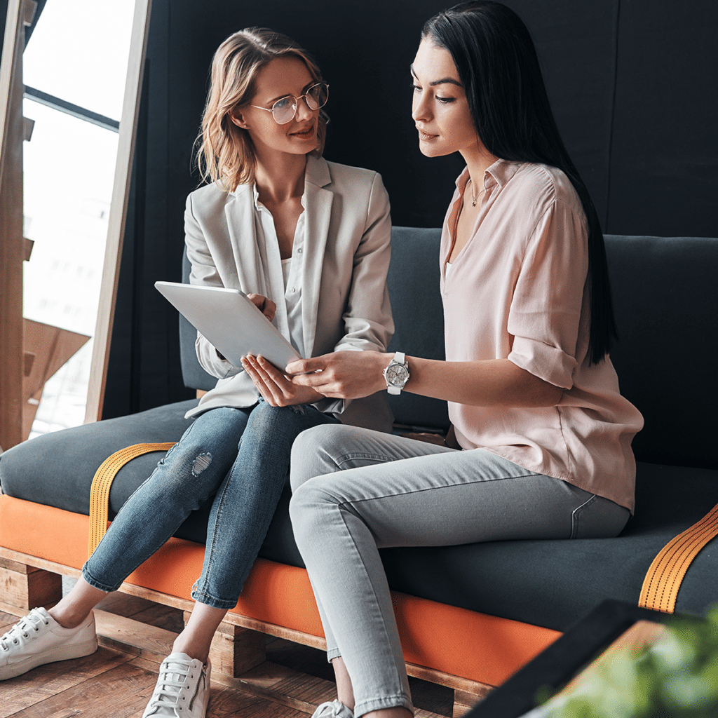 Smiling career women looking at ipad